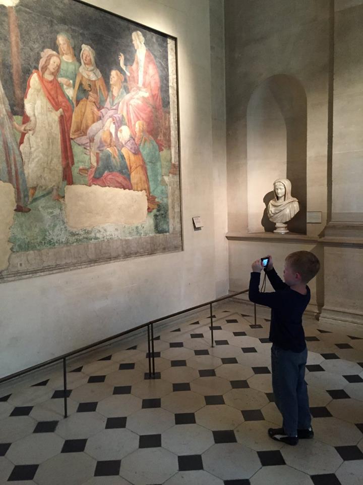 A taking photos at the Louvre.